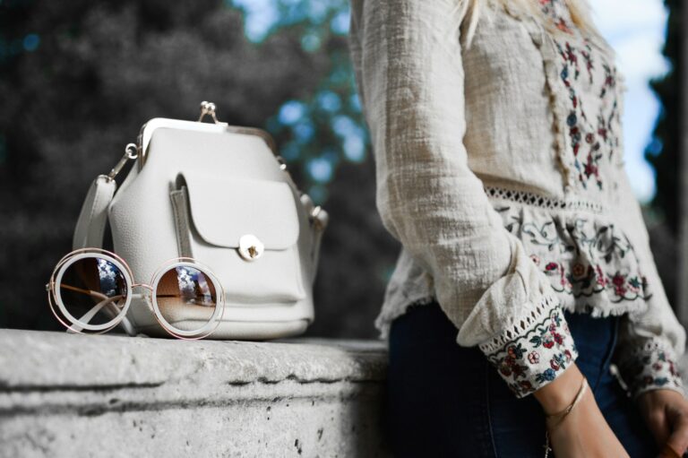 Flatlay blazer jeans white shirt leather bag