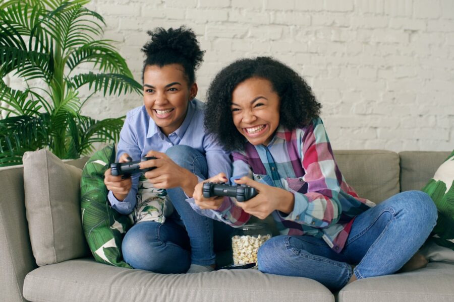 Family playing video game couch controllers