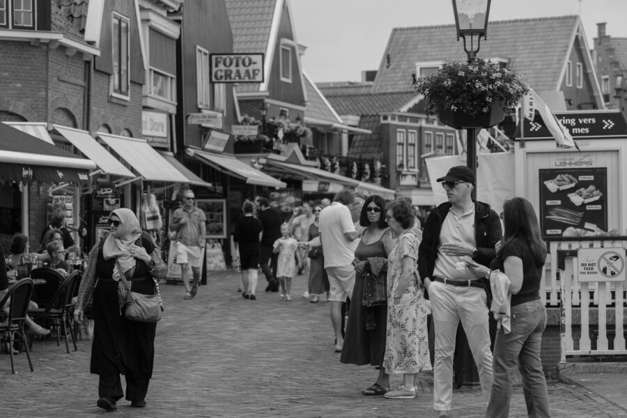 Tourists walking small european village street