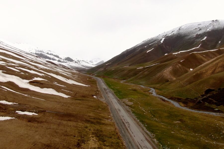 Travel documentary host camera mountain road