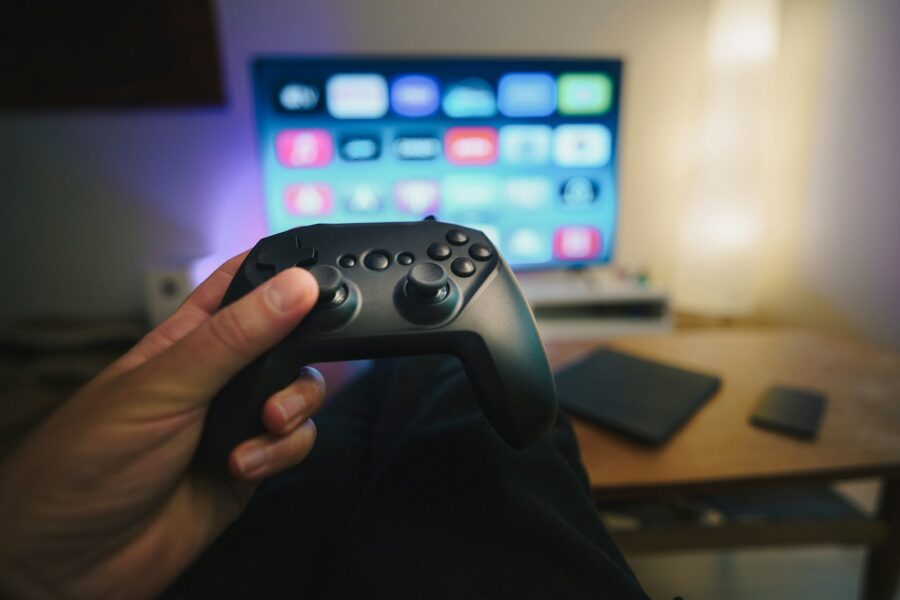 Person holding controller screen couch