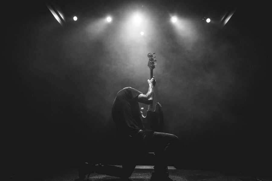 Singer acoustic guitar stage warm lights