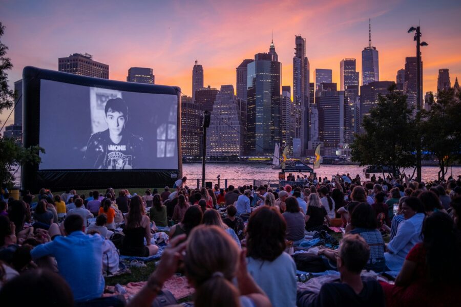 Outdoor movie screening park night crowd