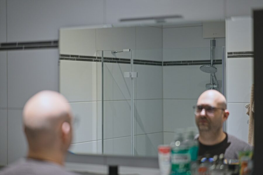 Man grooming routine bathroom mirror