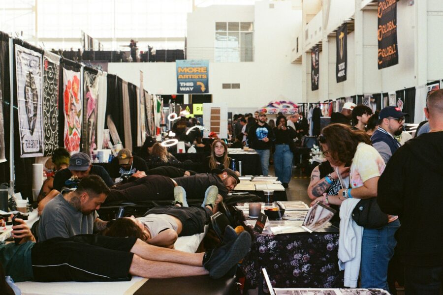Indoor art fair stalls visitors browsing