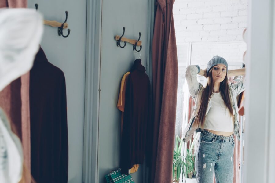 Woman standing wardrobe neutral clothes hangers