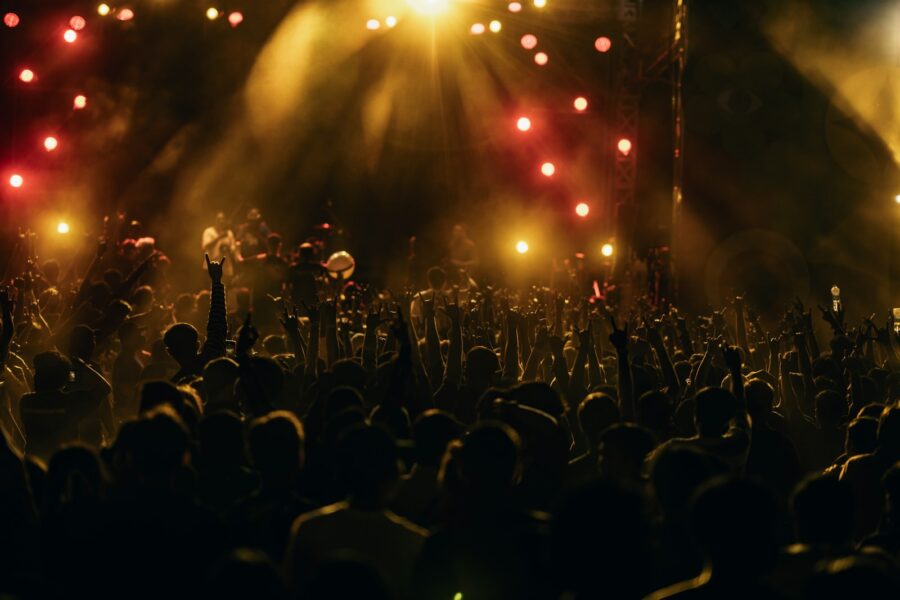 Stadium concert crowd sunset stage lights