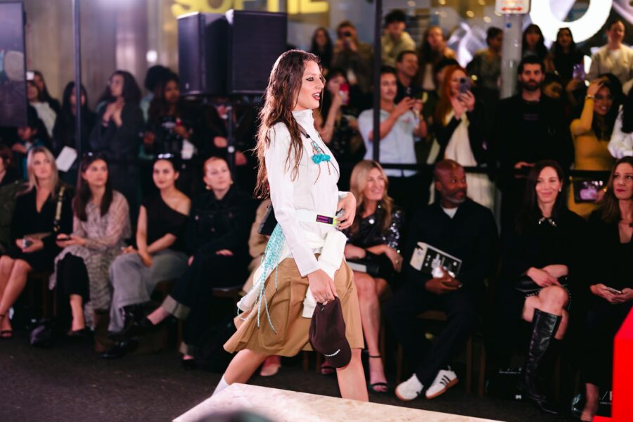 Fashion runway model walking audience front row