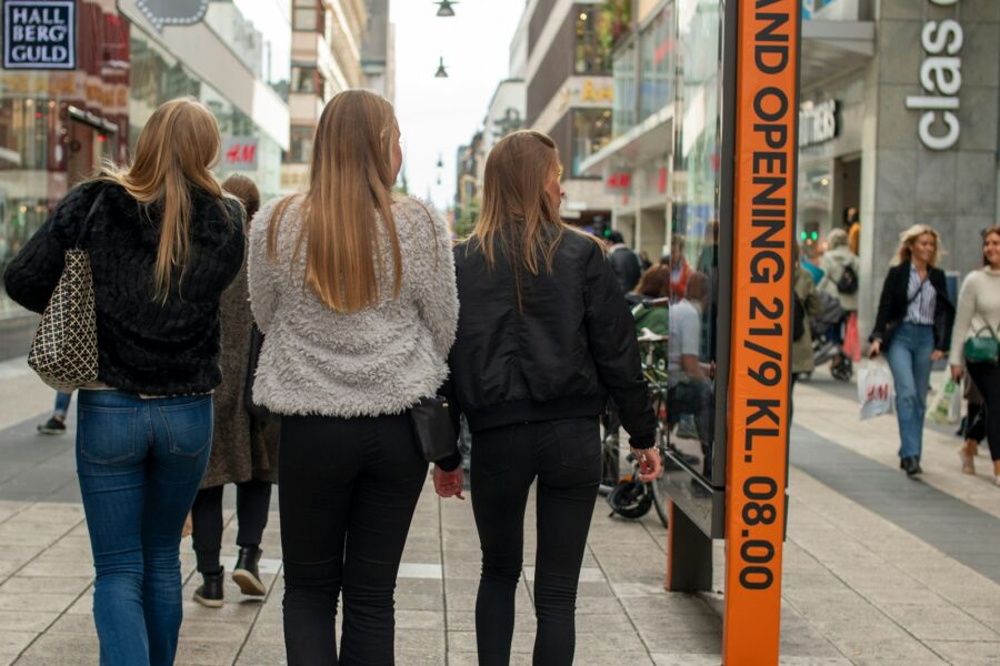 Stylish friends walking city street outfits