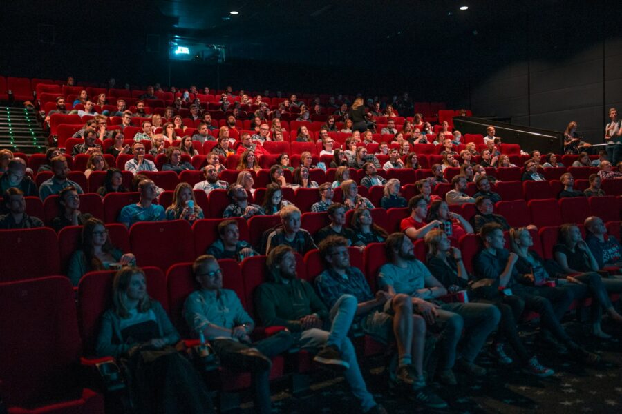 Cinema audience colorful movie poster arcade game