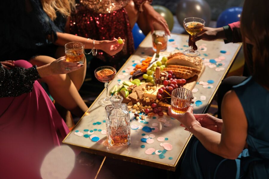 Friends sharing trendy snacks table
