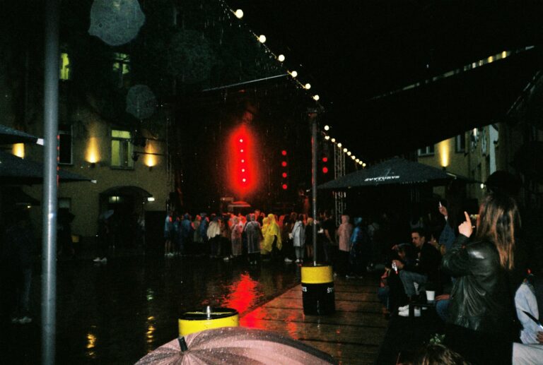 Crowd waiting rain outside venue