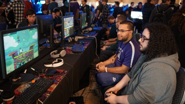 Small indie game booth developers talking