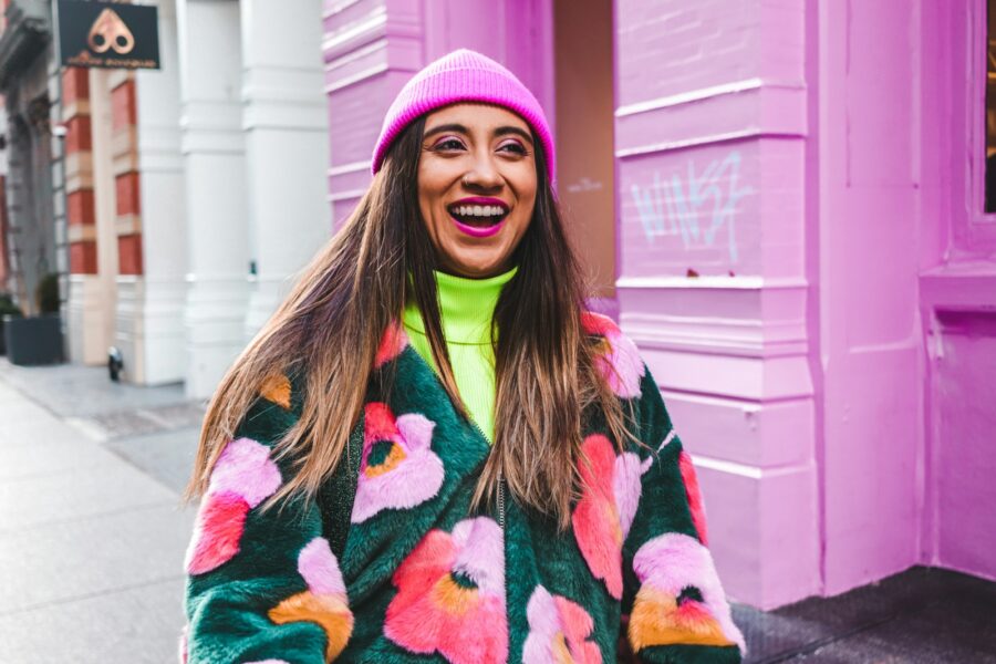 Street style woman wearing bright statement coat
