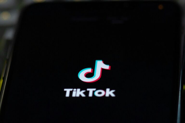 Smartphone tiktok app screen playing music nightclub crowd