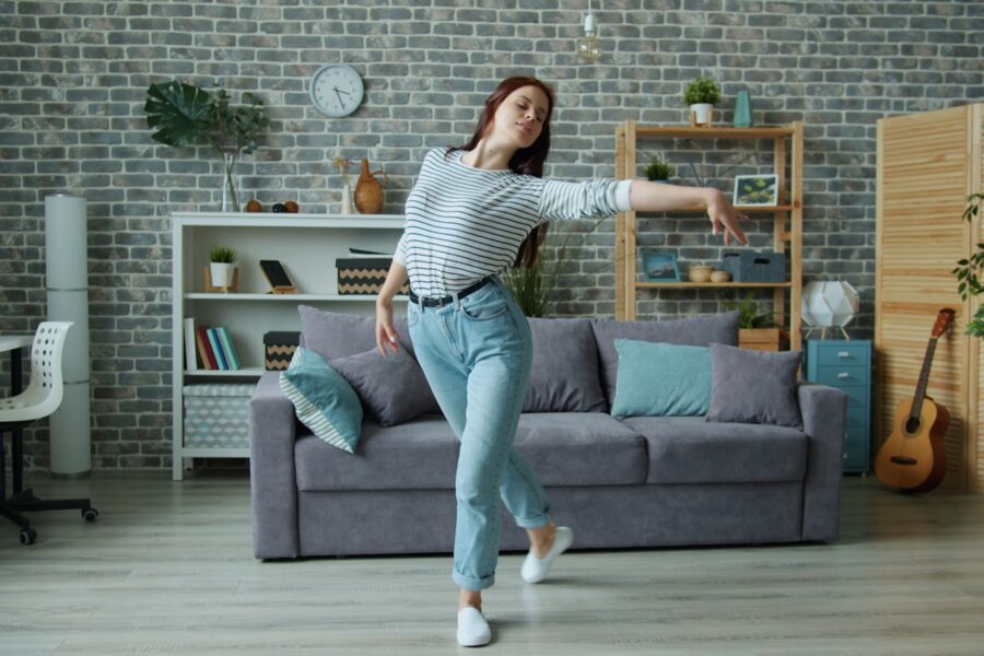 Friends dancing living room party lights