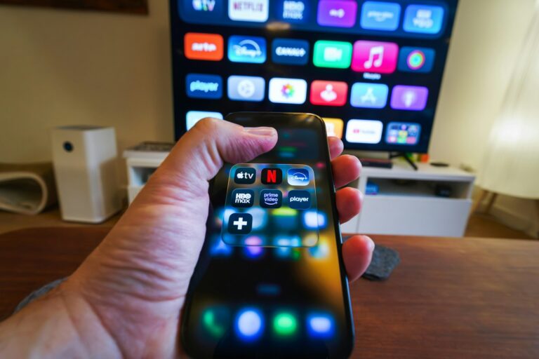 Close remote hand streaming app interface television screen