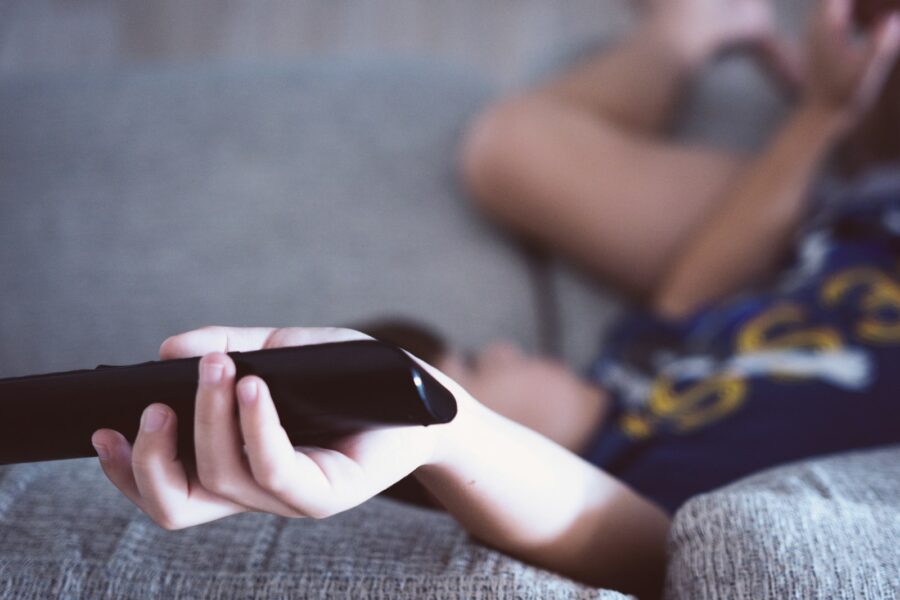 Person watching sofa remote blanket
