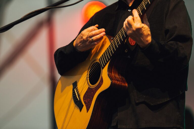 Musician performing acoustic guitar stage