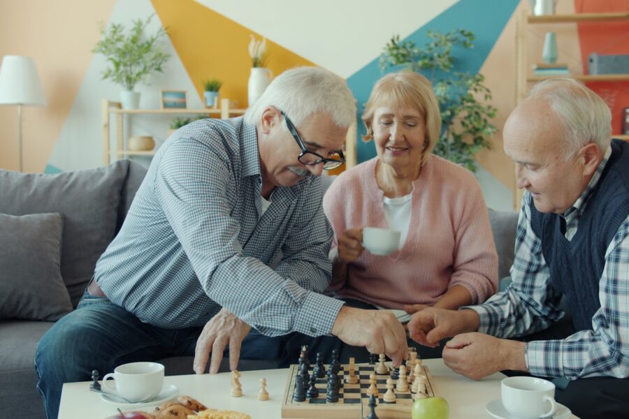 Friends playing board game living room table