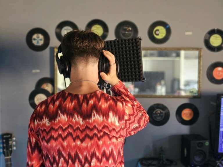 Young musician recording vocals home studio bedroom recording