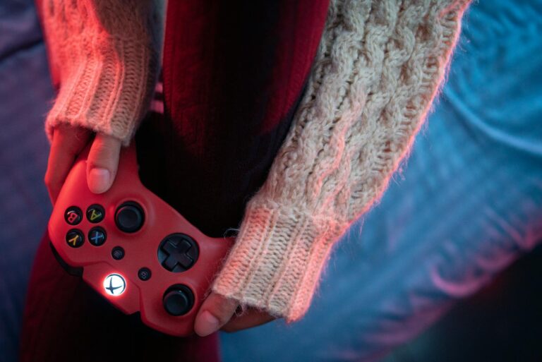 Cozy gaming setup warm lighting handheld game detail