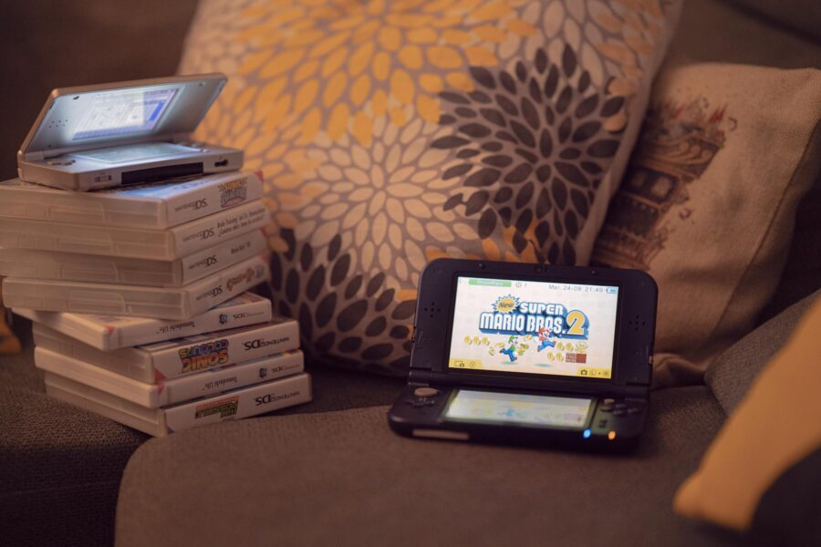 Cozy gaming setup warm lighting handheld game