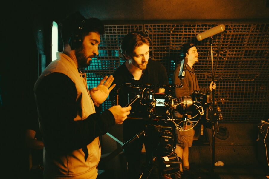 Independent film crew shooting scene handheld camera night