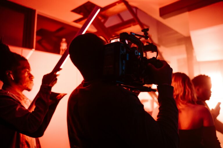 Independent film crew shooting scene handheld camera night