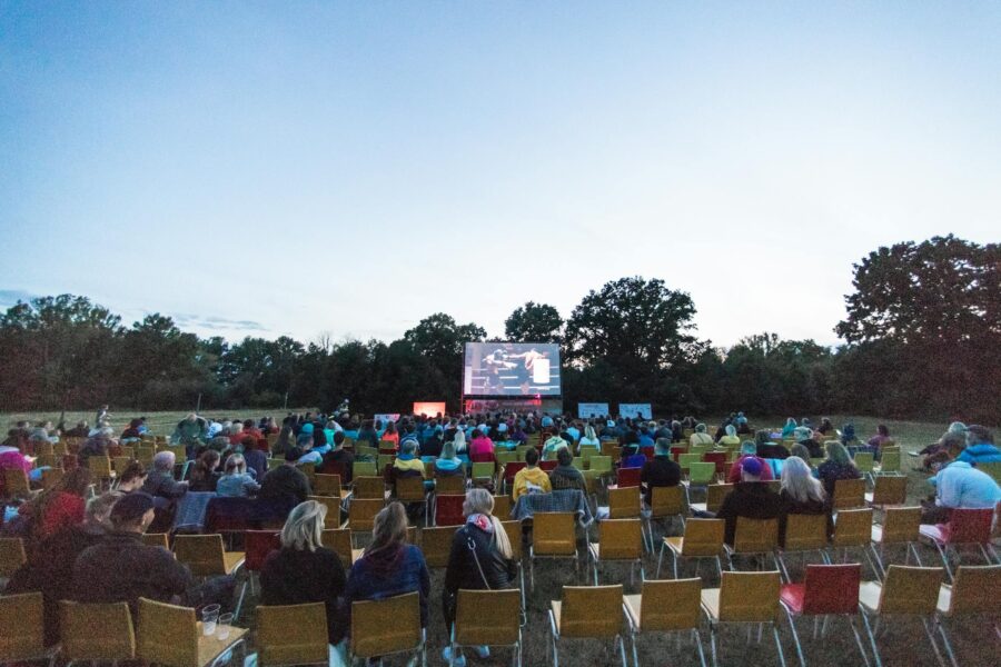 Outdoor summer movie screening park crowd blanket