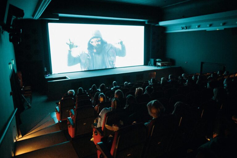 Cinema audience watching movie screen seats
