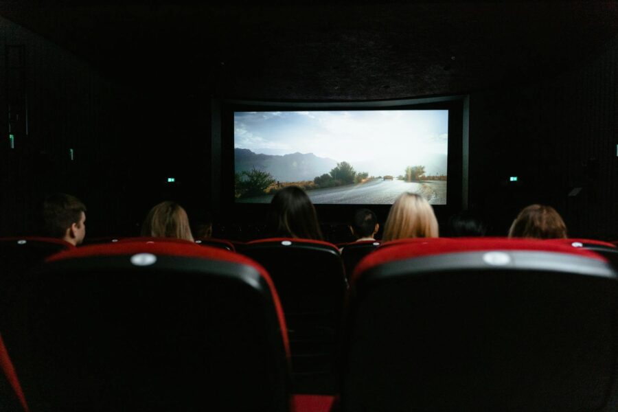 Cinema audience watching movie screen seats