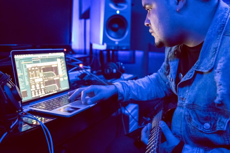 Music producer mixing vocal tracks laptop