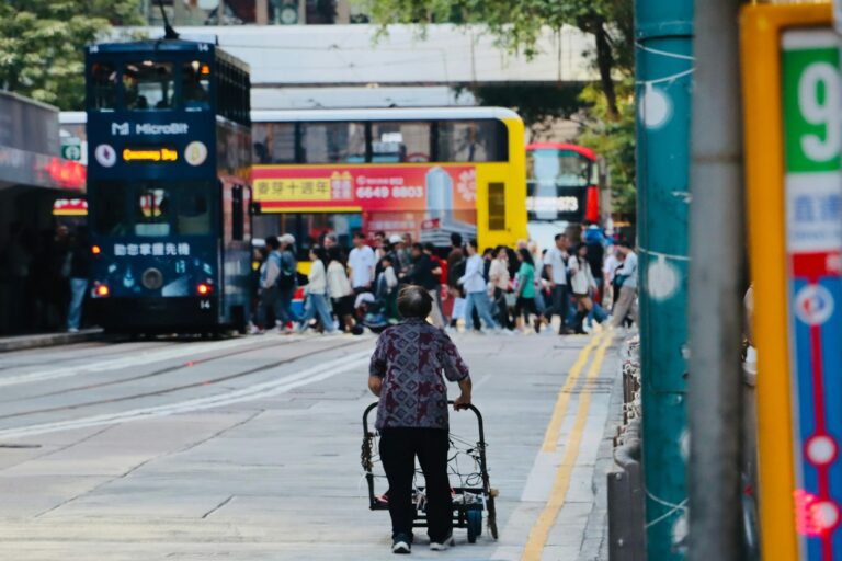 Man pushing stroller casual outfit city crosswalk