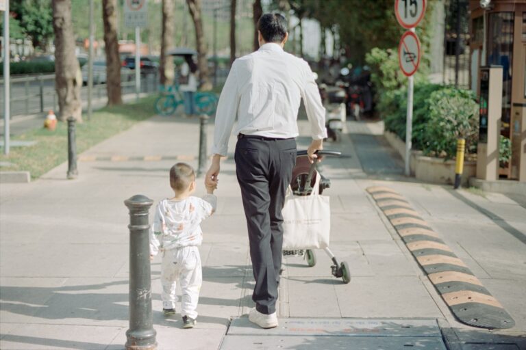 Stylish father walking stroller streetwear outfit detail