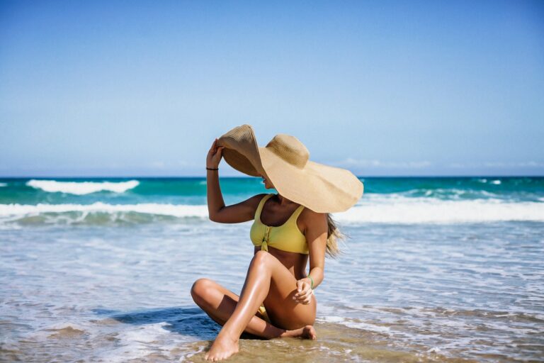 Woman sustainable swimwear beach ocean sand