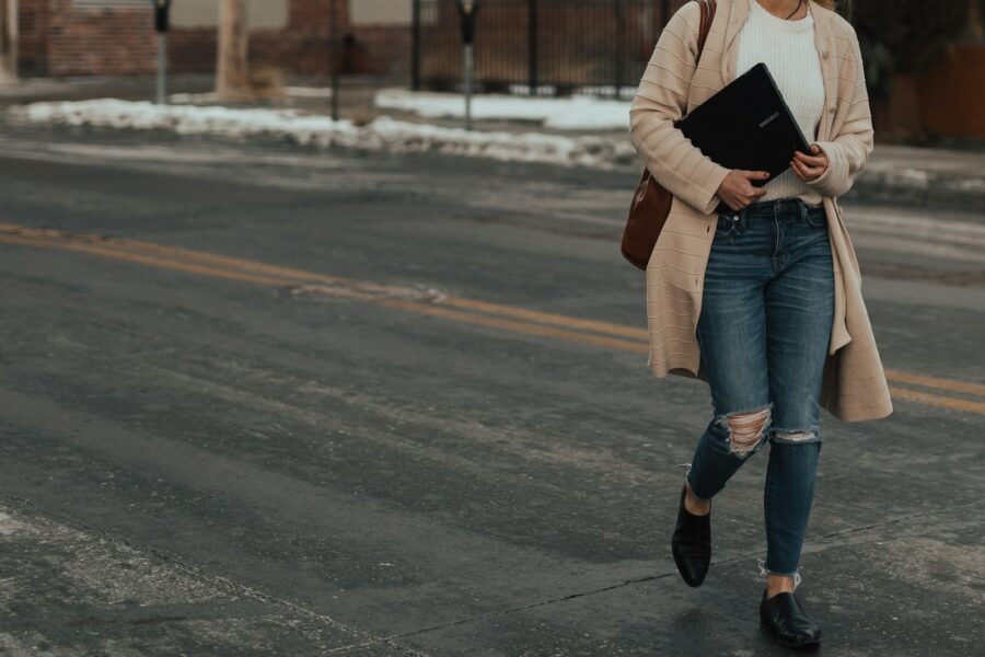 Neutral street style outfit beige coat jeans sneakers