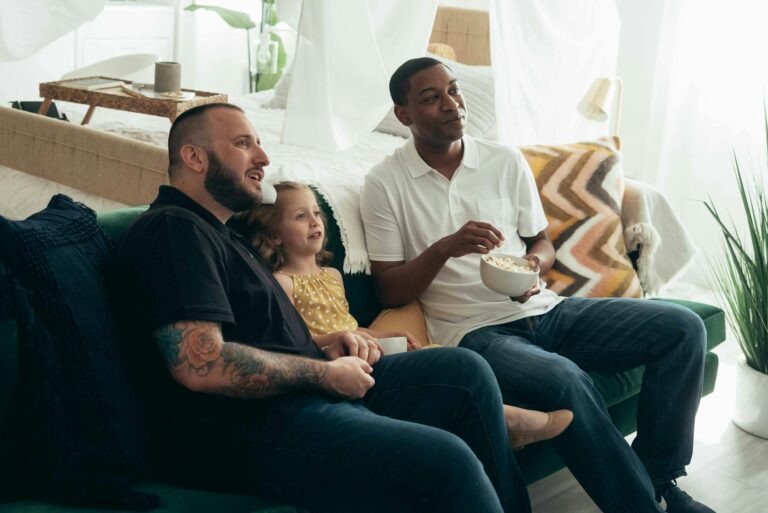 Family watching together sofa home movie night popcorn